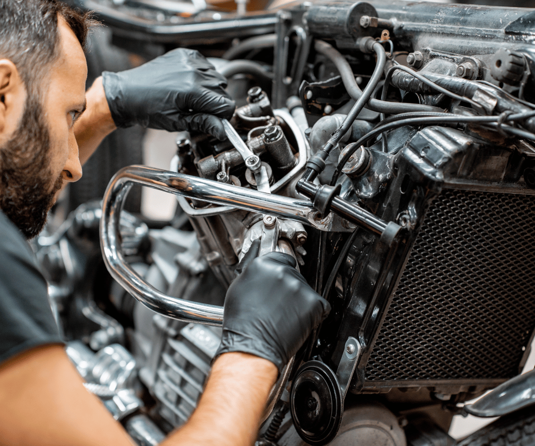 a man working on an engine wearing nitrile gloves